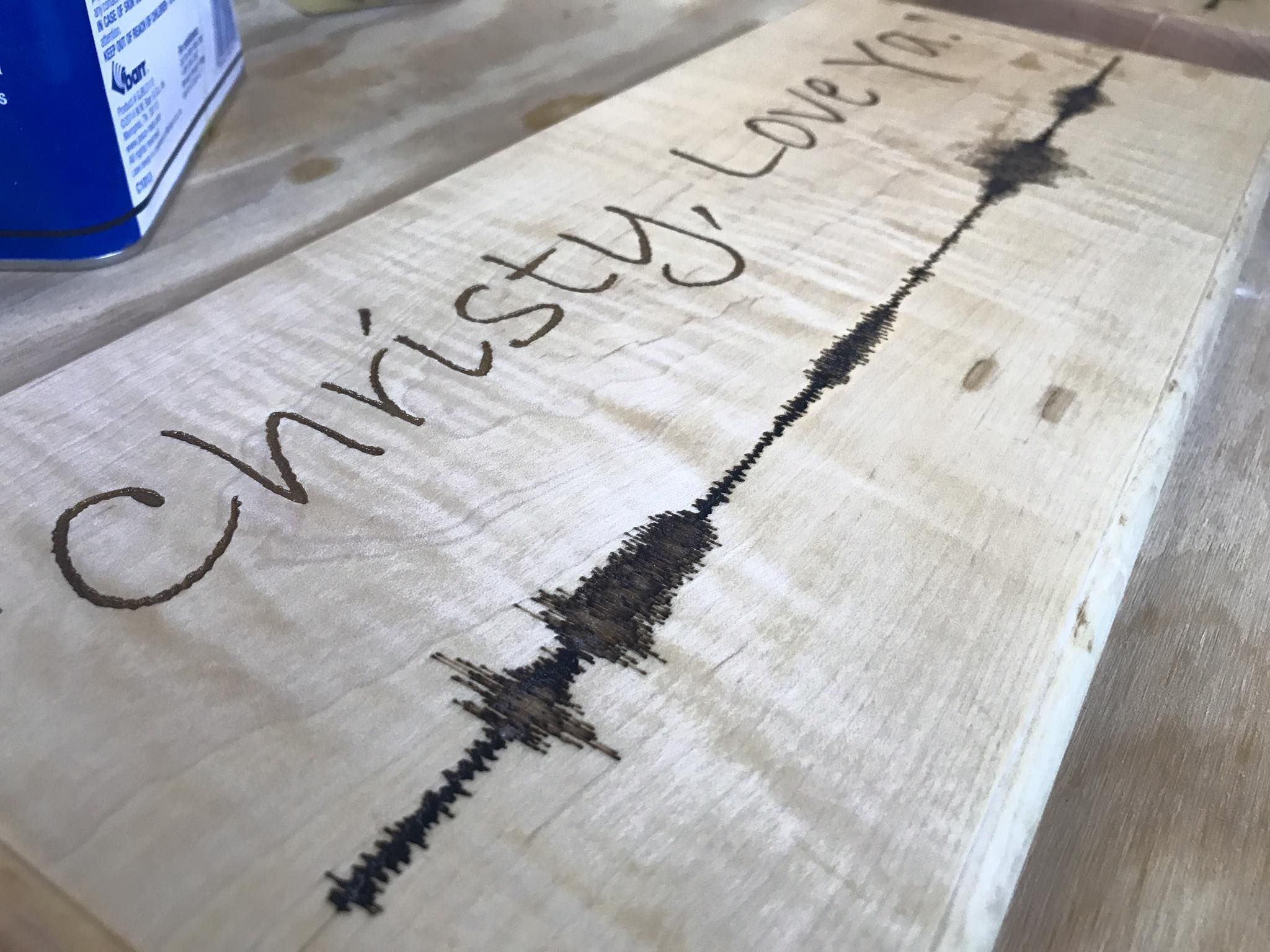 Maple board engraved with a handwritten 'Christy, Love Ya' and the soundwave of the recording